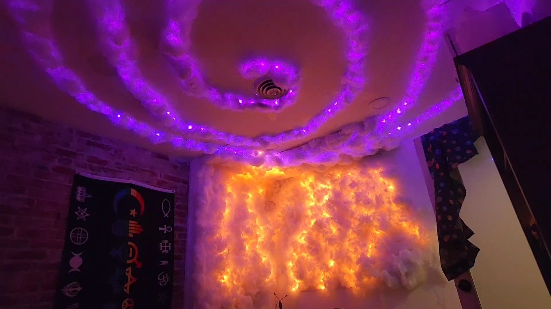 Avalon treatment room with purple spiral LED ceiling and amber-glowing cloud wall